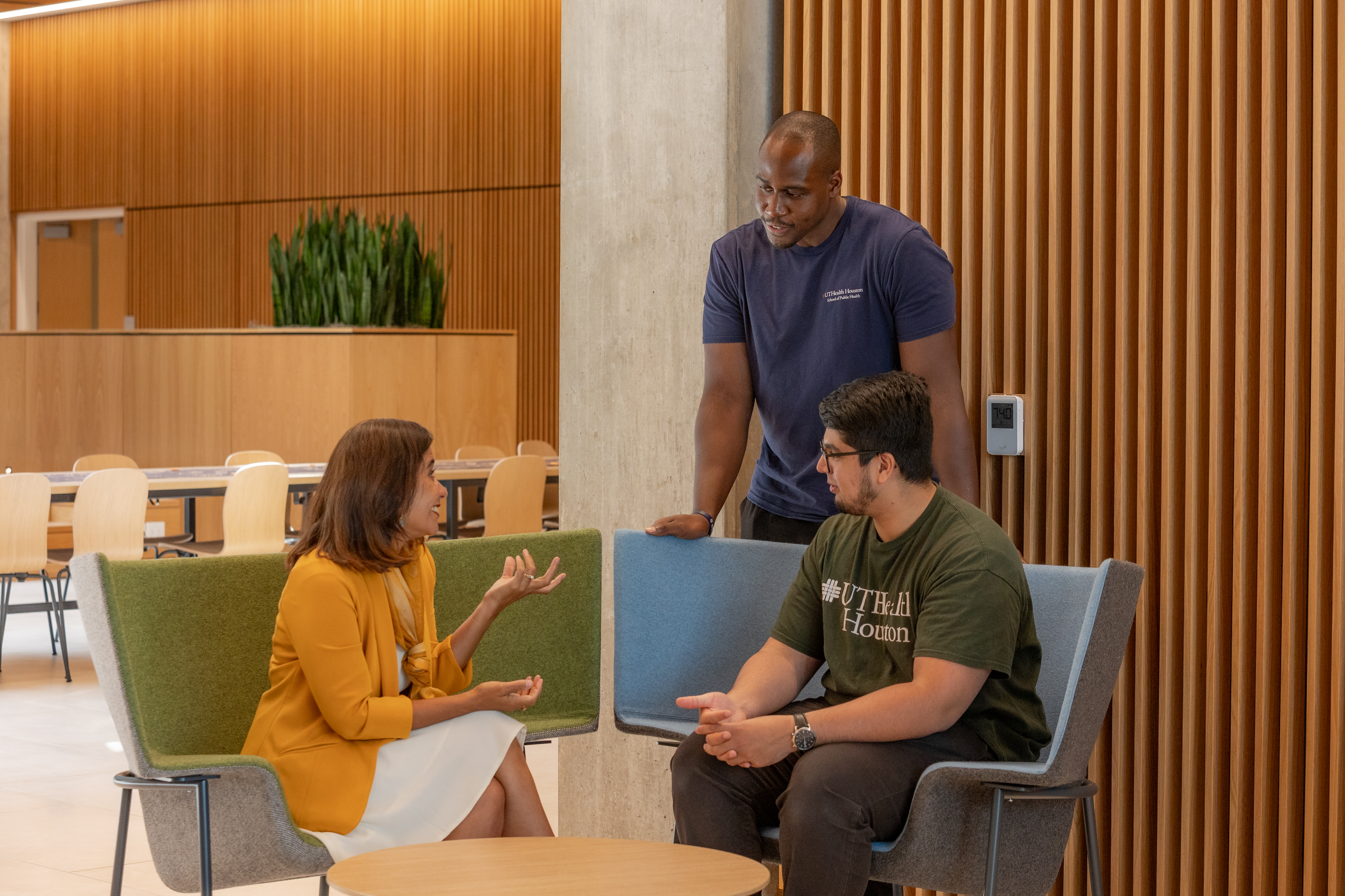 Faculty member talking with two students